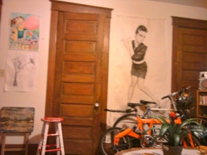 Here you can see the bikes a little better and more of Valerie's work that's been put up in the living room.